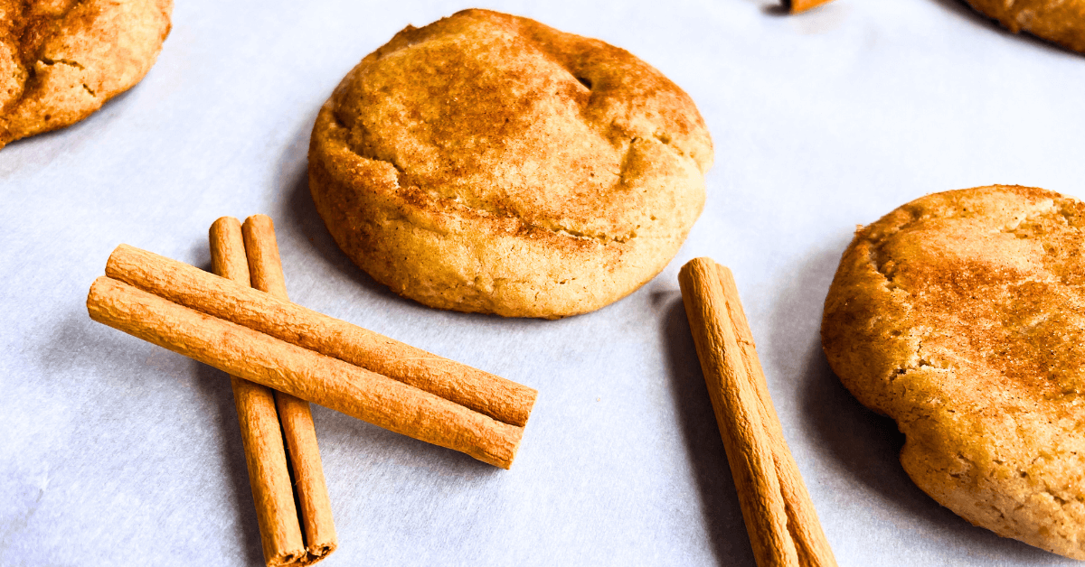 close up of apple pie snickerdoodle with cinnamon sticks on parchment paper