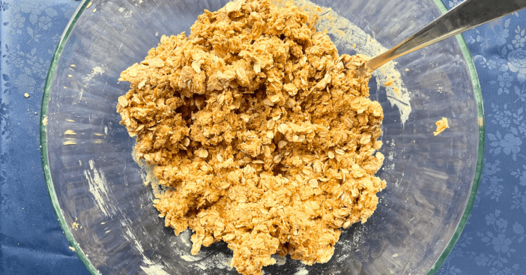 peanut butter, oats, protein powder and honey mixed together in a glass bowl
