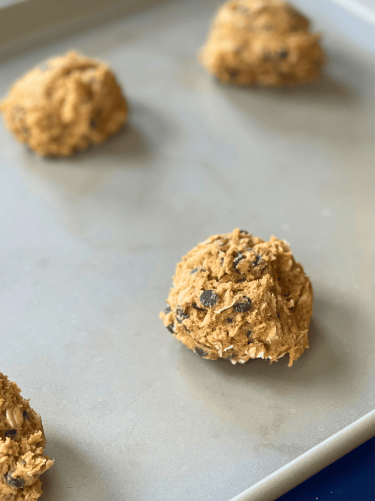 close shot of oatmeal pumpkin chocolate chip cookie dough balls on a baking tray