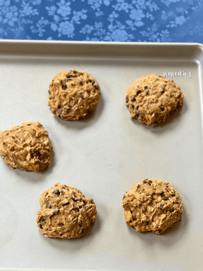 freshly baked oatmeal pumpkin chocolate chip cookies resting on a cookie sheet