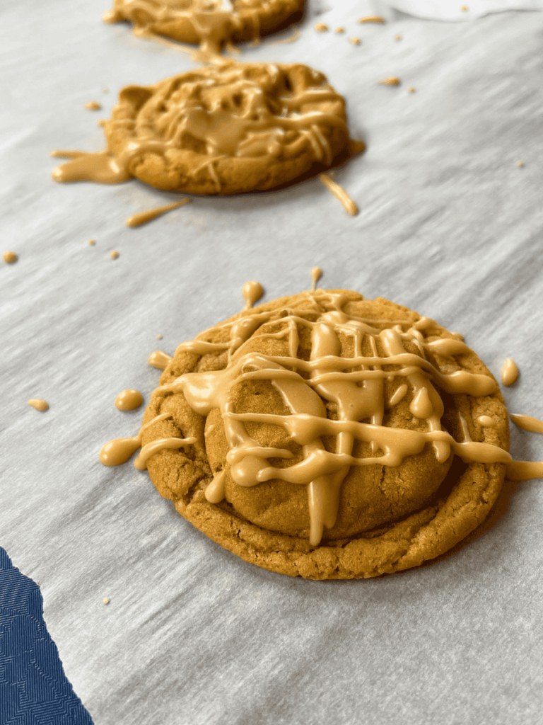 maple peanut butter cookies resting on parchment paper