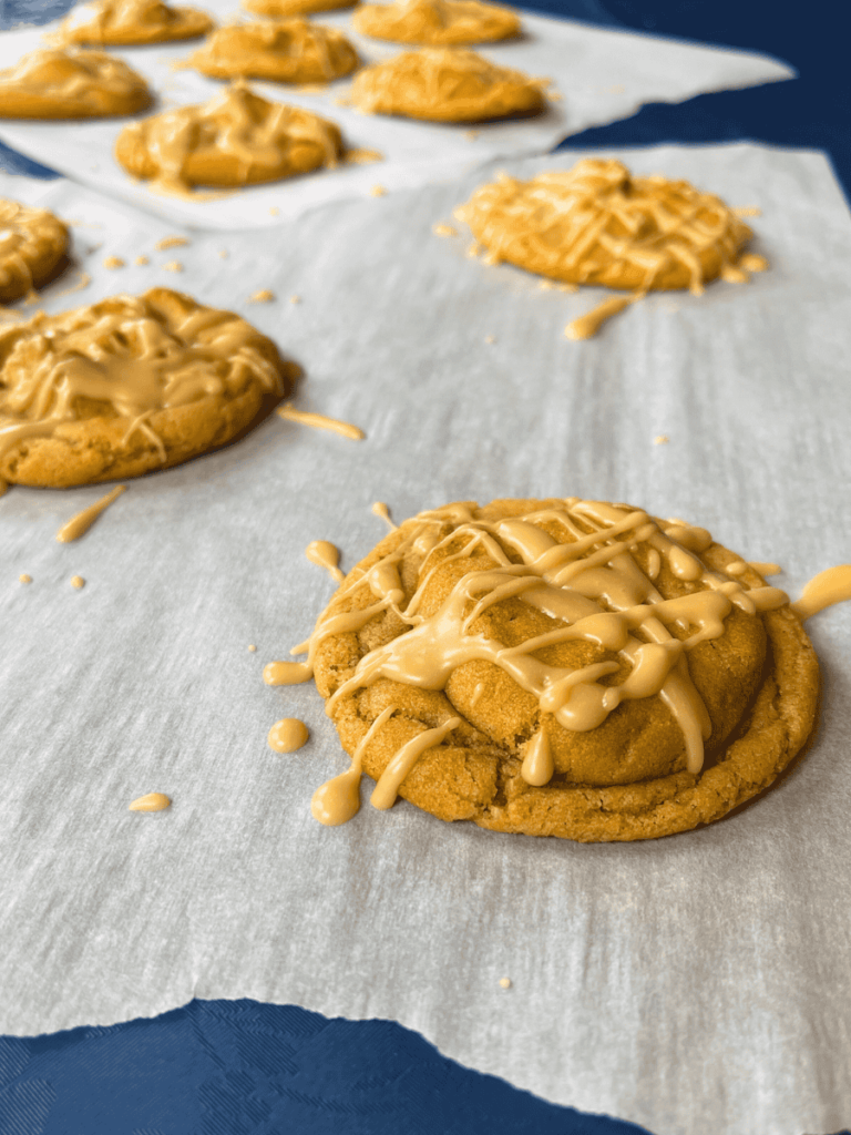 maple peanut butter cookies resting on parchment paper