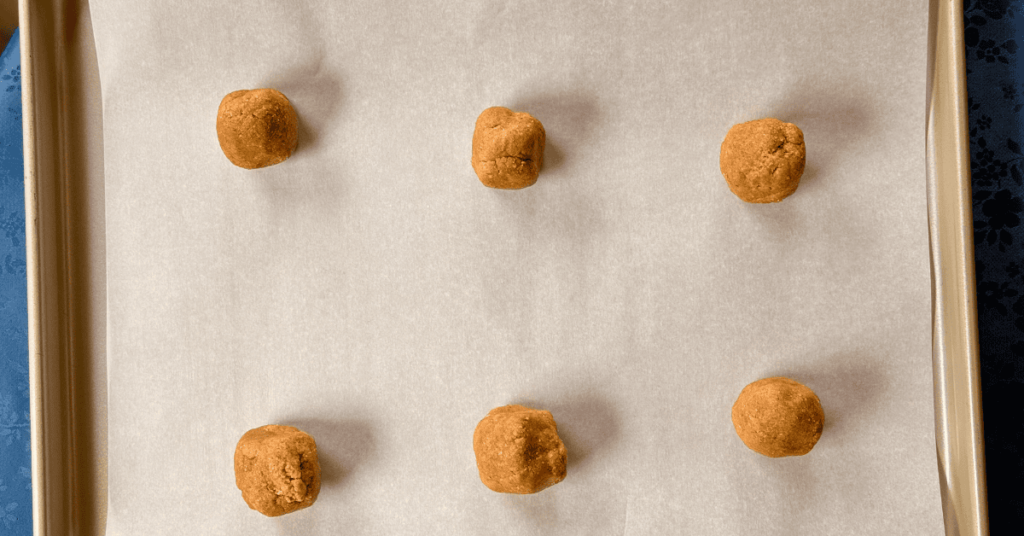 6 graham cookie cubes spaced out about 3" on a parchment lined baking sheet