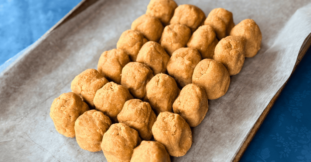 24 graham cookie cubes touching and set on a parchment lined cookie tray