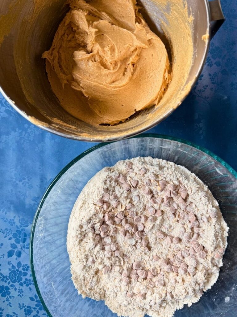 mixed dry and wet ingredients for peanut butter oatmeal cookies in separate bowls